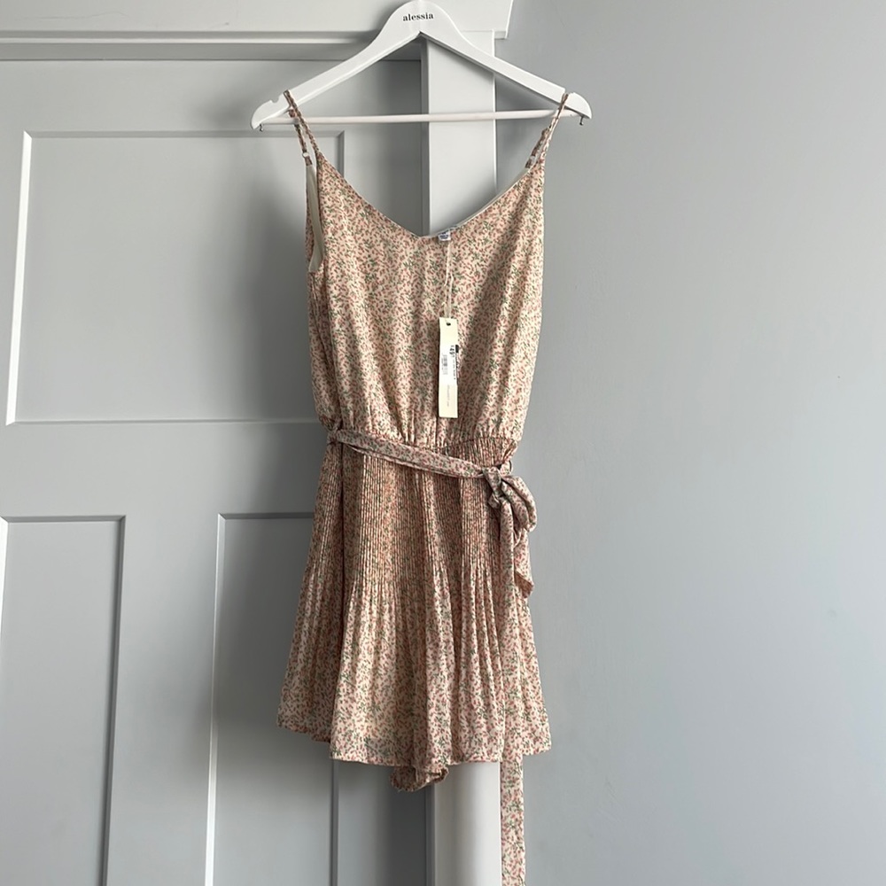 Floral romper .   Pleaded skort bottoms. Size M